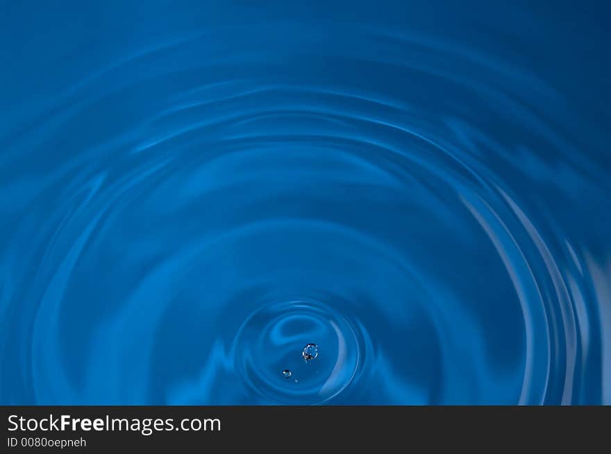 Drop of water above rippled water. Drop of water above rippled water