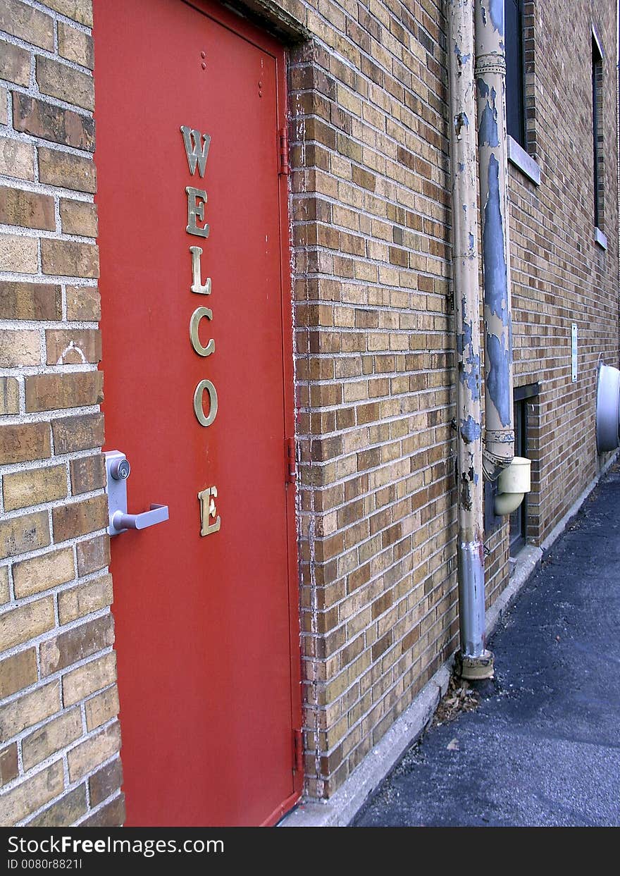 A red door in an alleyway. A red door in an alleyway.