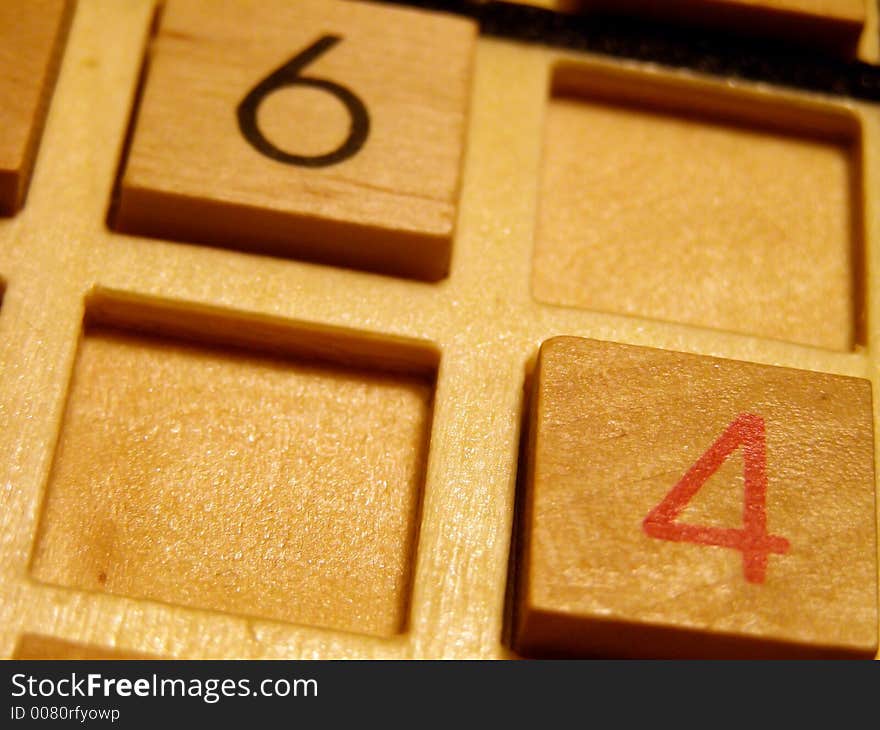 Wood sudoku board and tiles.