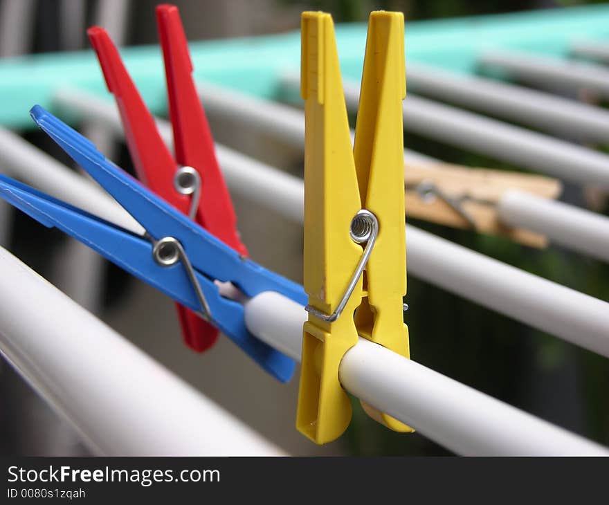 Some colored clothes pegs on a clothes line