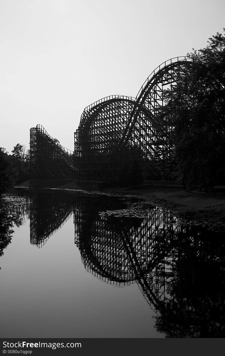 Wooden rollercoaster with a lake reflection - vertical composition. Wooden rollercoaster with a lake reflection - vertical composition