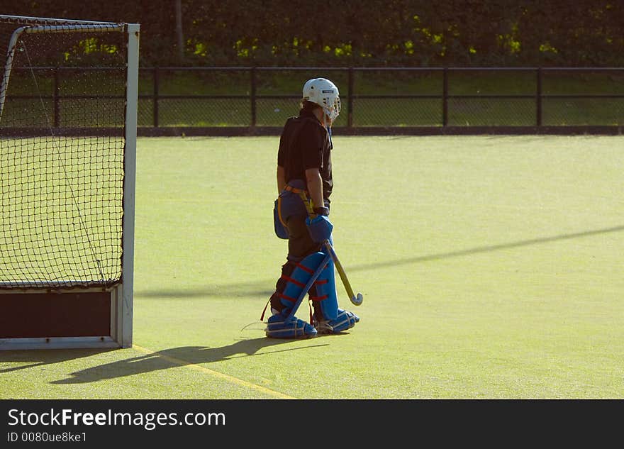 Hockey goalkeeper on a green field