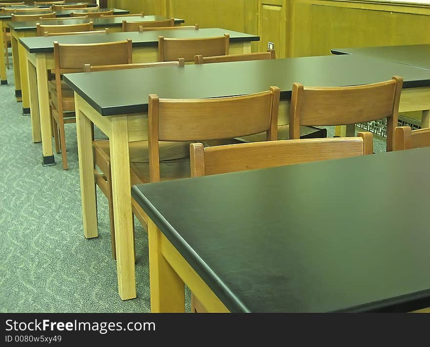 Old-fashioned desks and chairs.