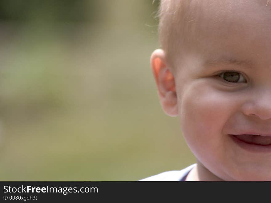 Half baby boy's face out of the right side of the frame. Half baby boy's face out of the right side of the frame