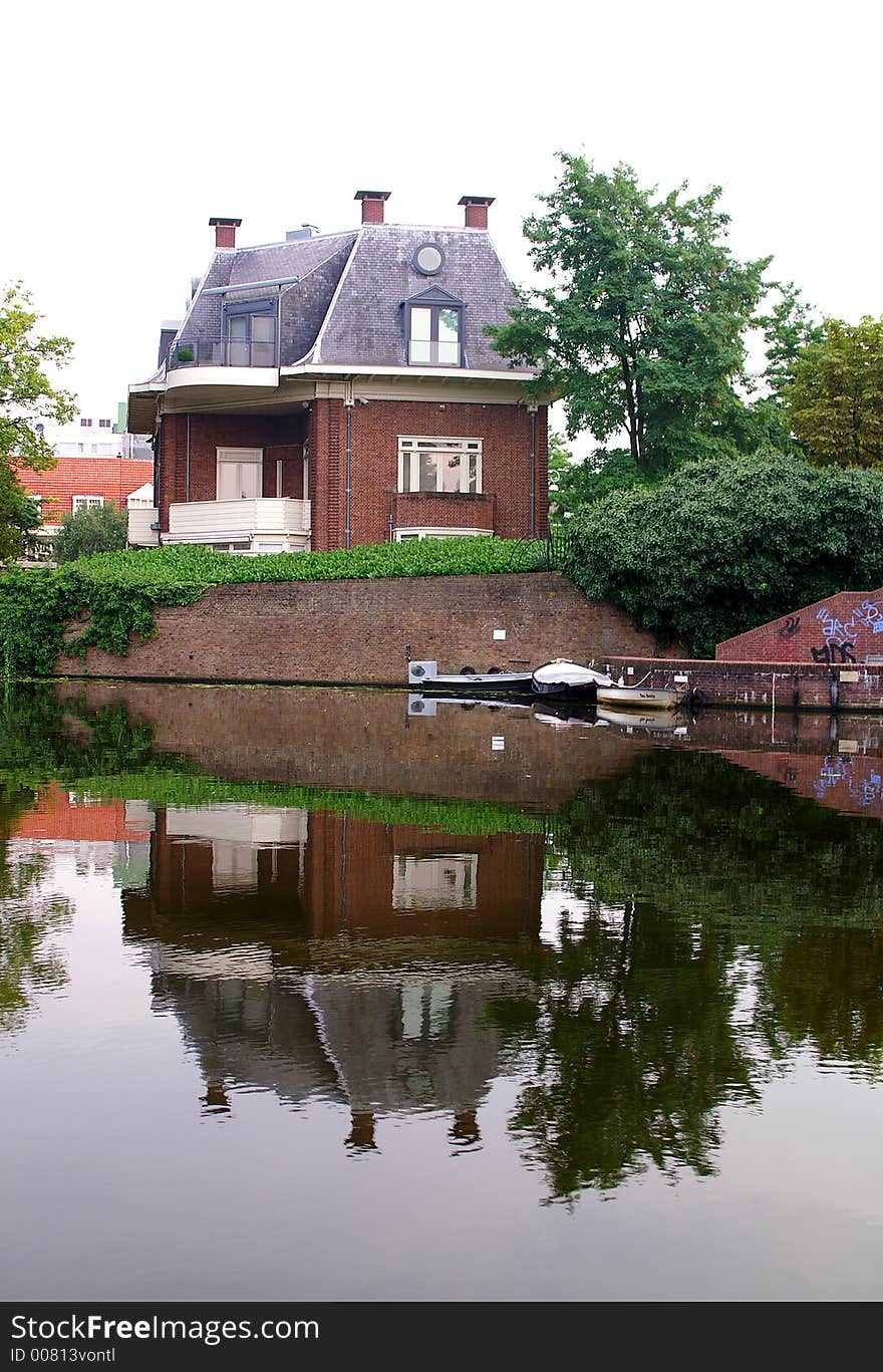 A House by the river side and its reflection. A House by the river side and its reflection