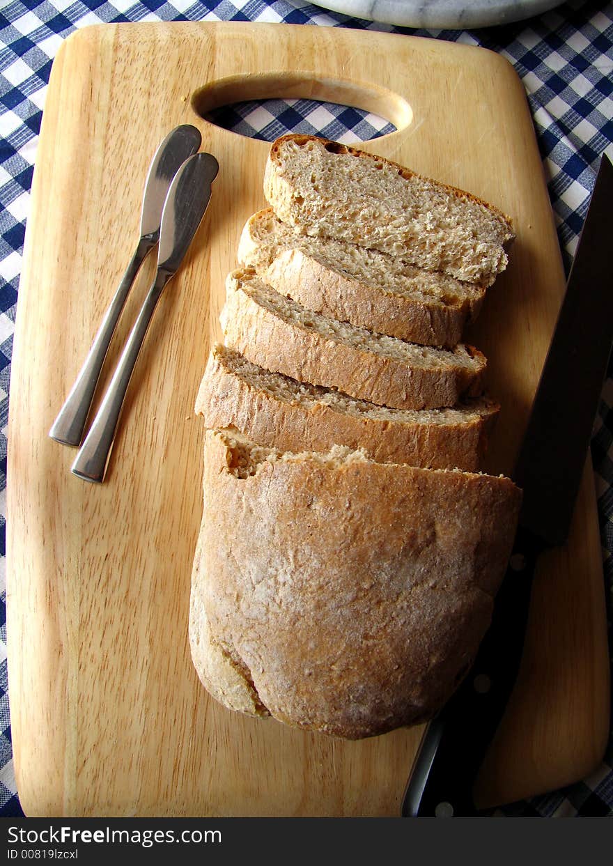 Tradicional bread, sliced on a wooden plate. Tradicional bread, sliced on a wooden plate.