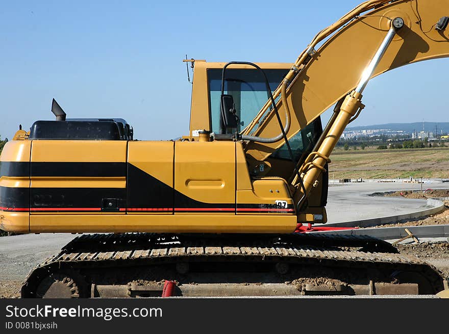 Excavator workink on road outside