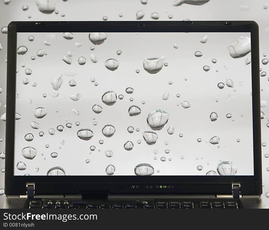 Notebook with rain drops on screen. Notebook with rain drops on screen