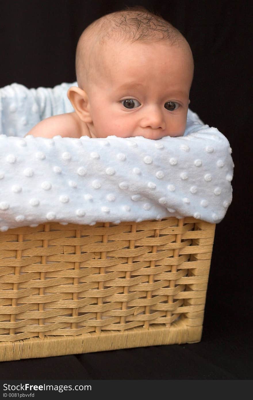 Baby boy sitting in basket. Baby boy sitting in basket