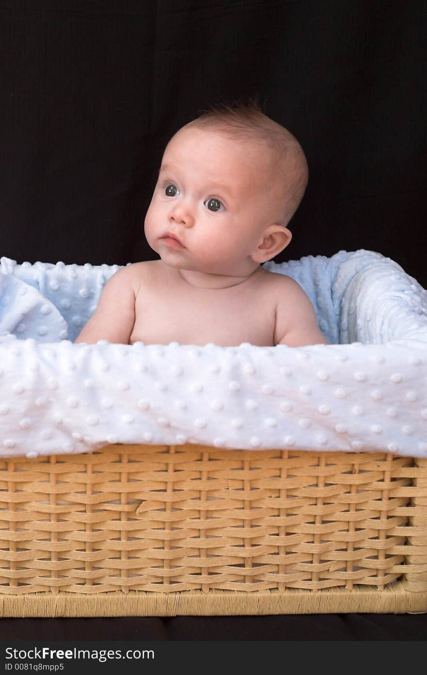 Baby boy sitting in basket. Baby boy sitting in basket