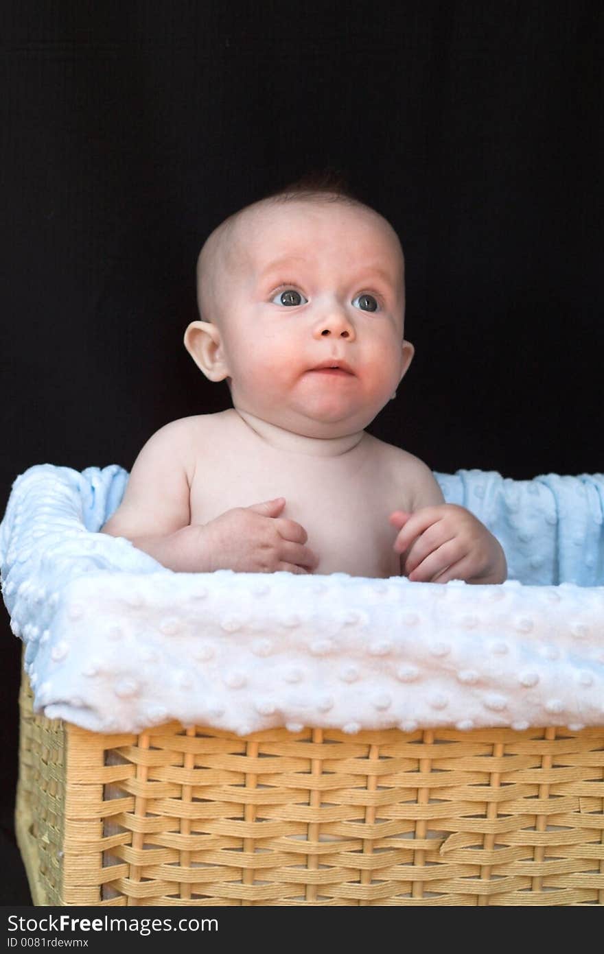 Baby boy sitting in basket. Baby boy sitting in basket