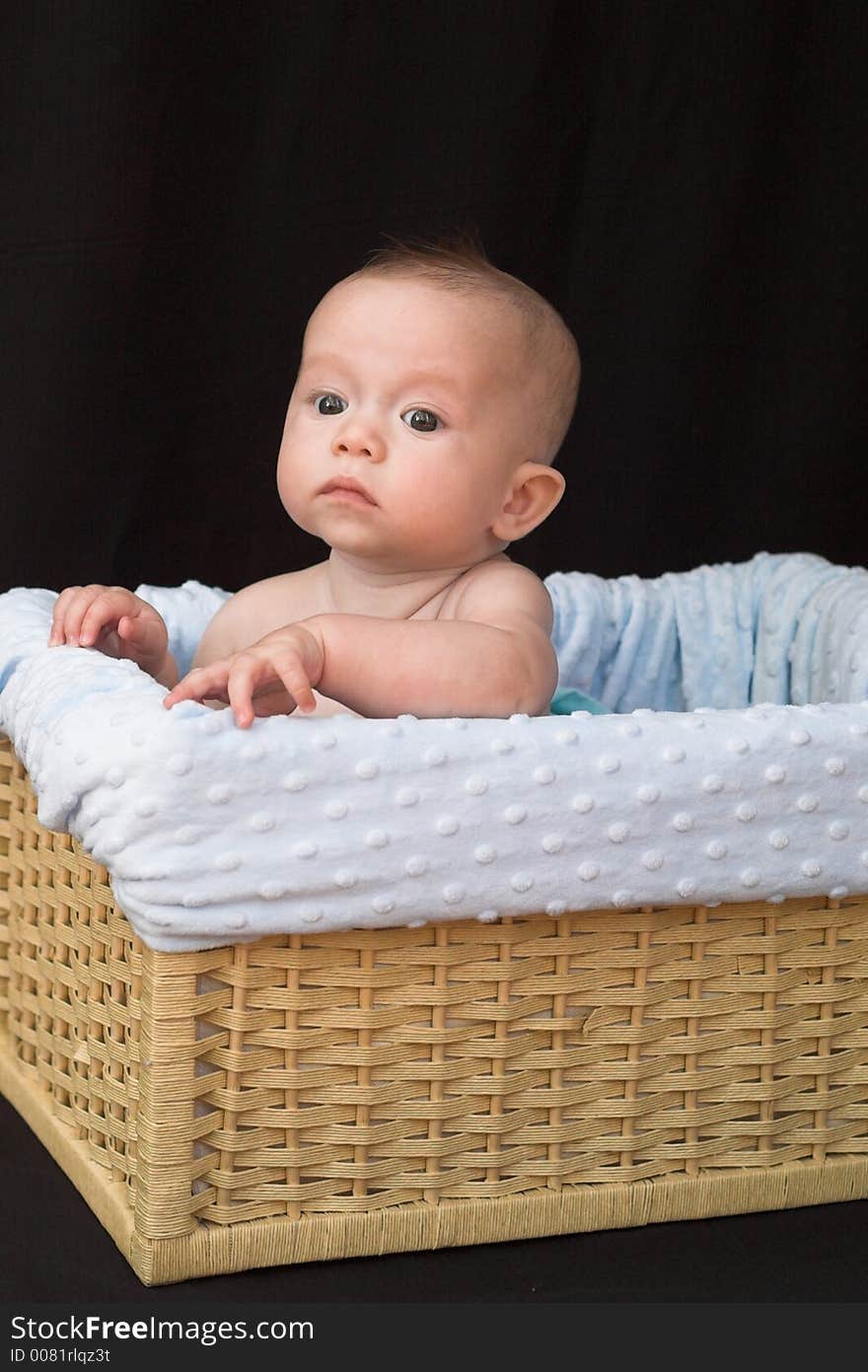 Baby boy sitting in basket. Baby boy sitting in basket