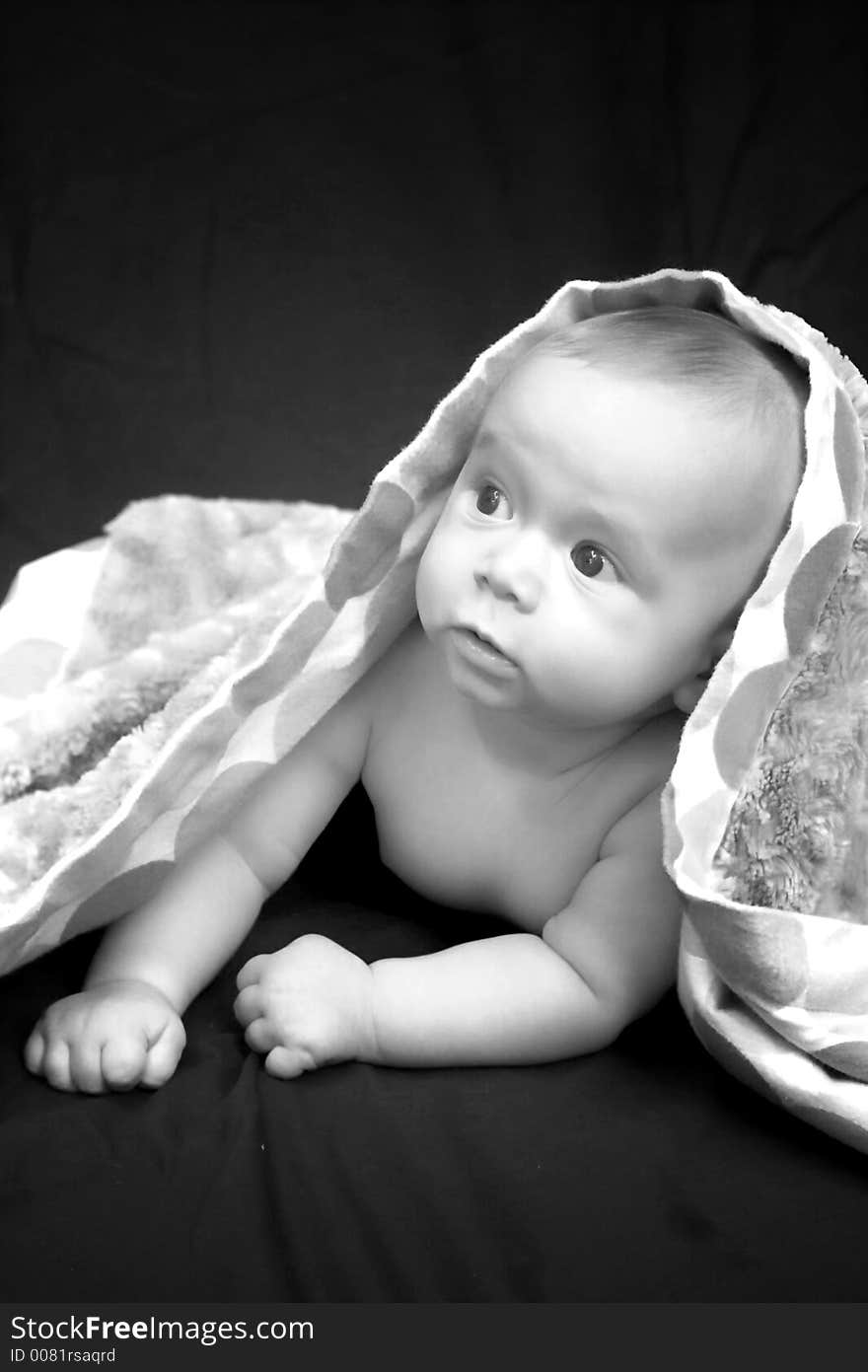 Portrait of baby boy covered by a blanket. Portrait of baby boy covered by a blanket