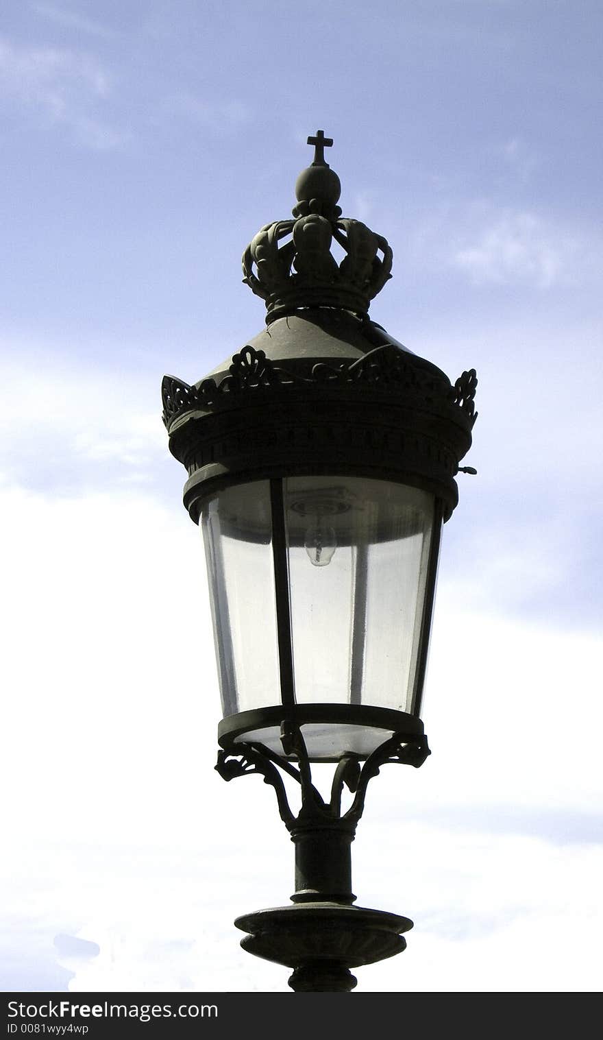 Medieval bronze street lantern with crown and cross. Medieval bronze street lantern with crown and cross