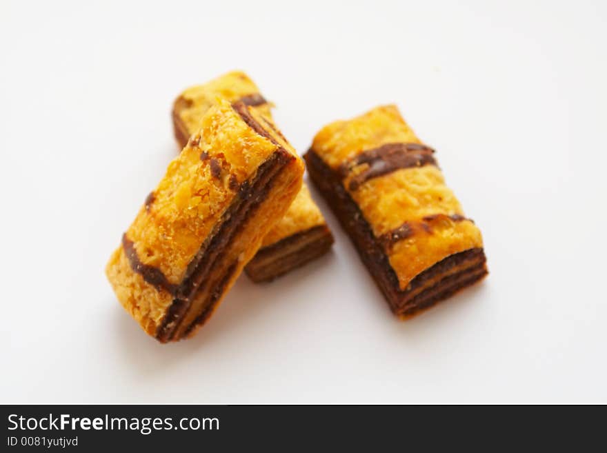 Three yellow puff cookies on white background