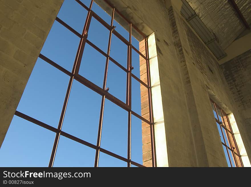 Warehouse window looking out over blue sky