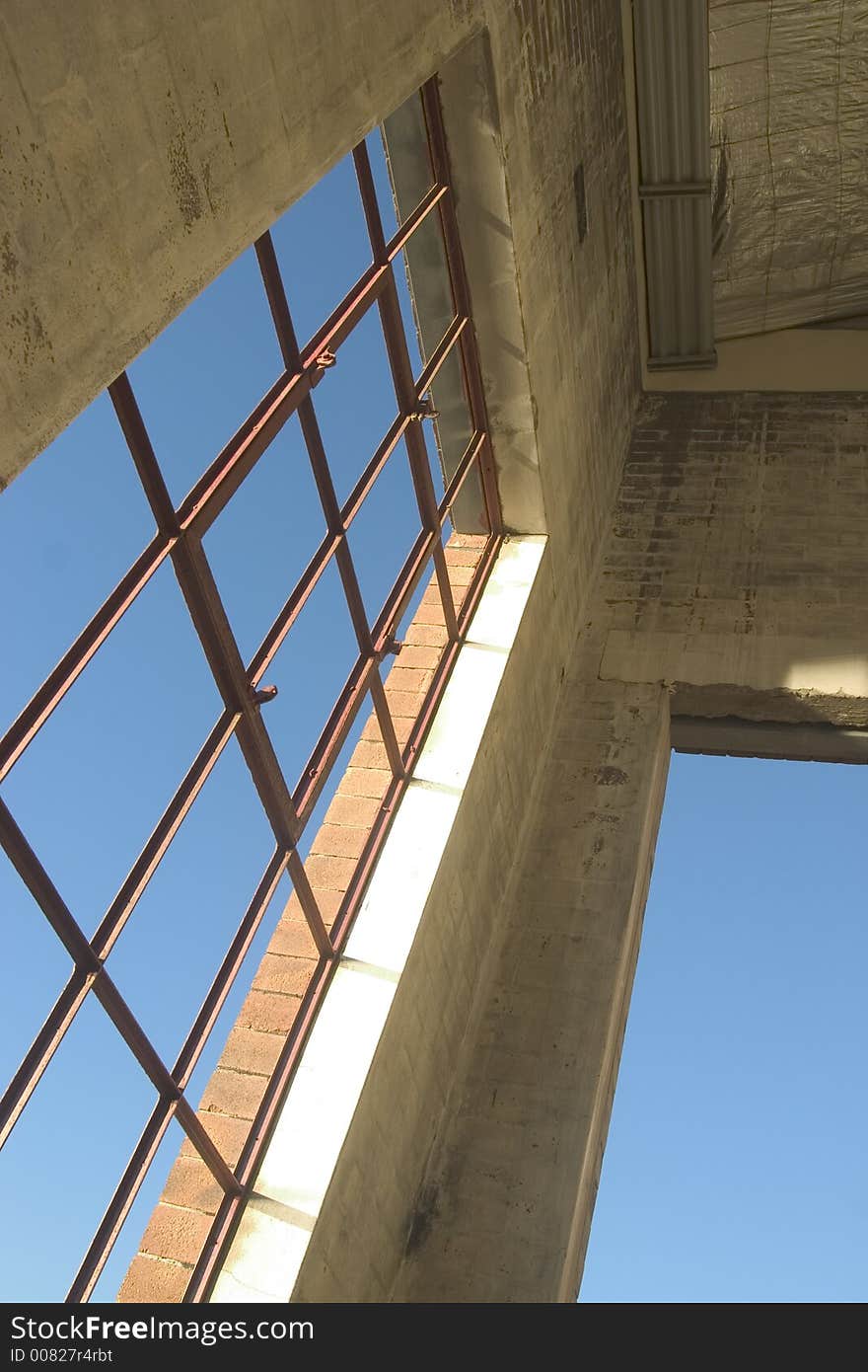 Warehouse window looking out over blue sky