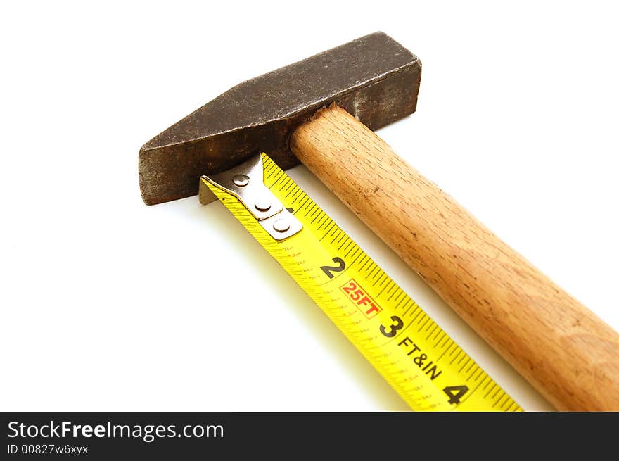 Yellow measure tape and hammer on white background. Yellow measure tape and hammer on white background