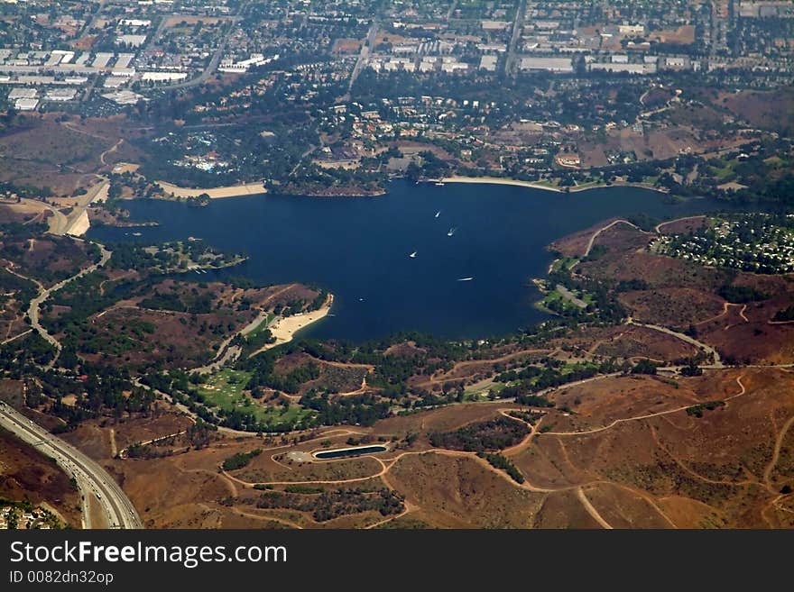 Artificial water reservoir with dam