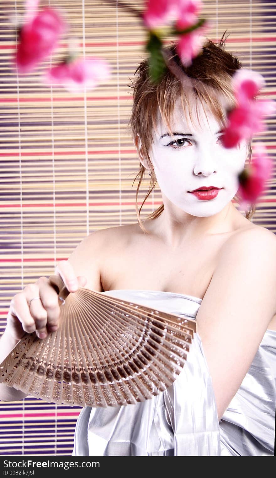 Attractive young  tradition girl with fan.