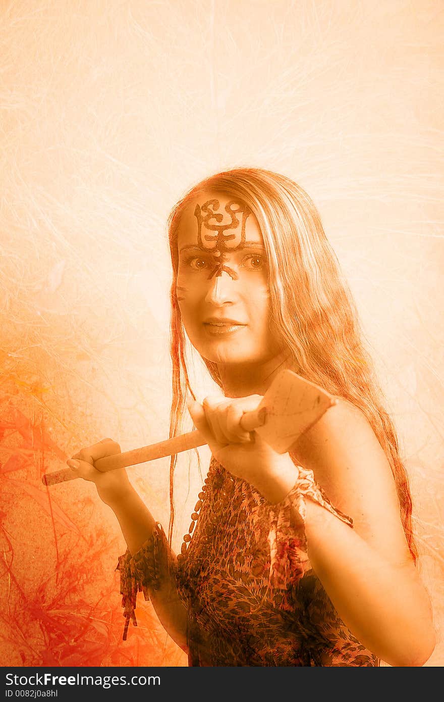 Shot of an girl holding african spear. Shot in studio. Shot of an girl holding african spear. Shot in studio.