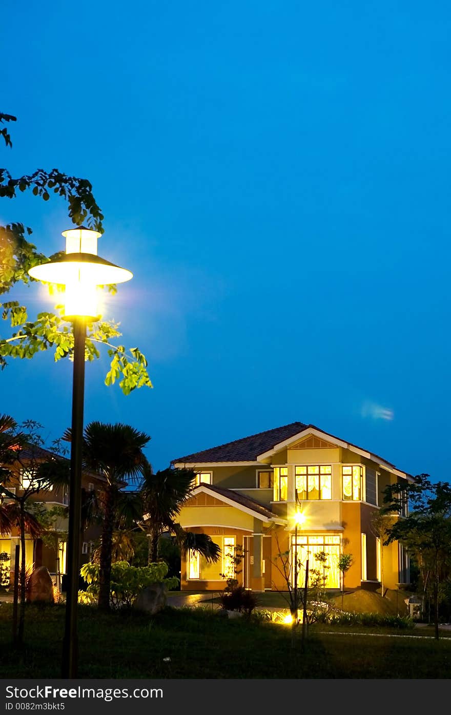 Evening scene, house and lamp pole with dark blue sky. Evening scene, house and lamp pole with dark blue sky.