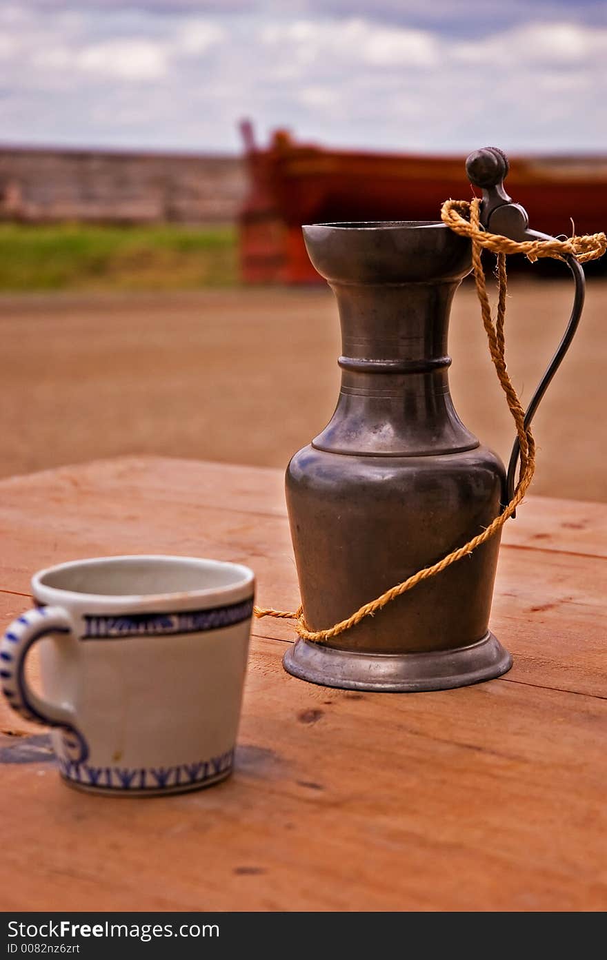 A cup and gauntlet sitting on a table in the streets of Louisbourg. A cup and gauntlet sitting on a table in the streets of Louisbourg