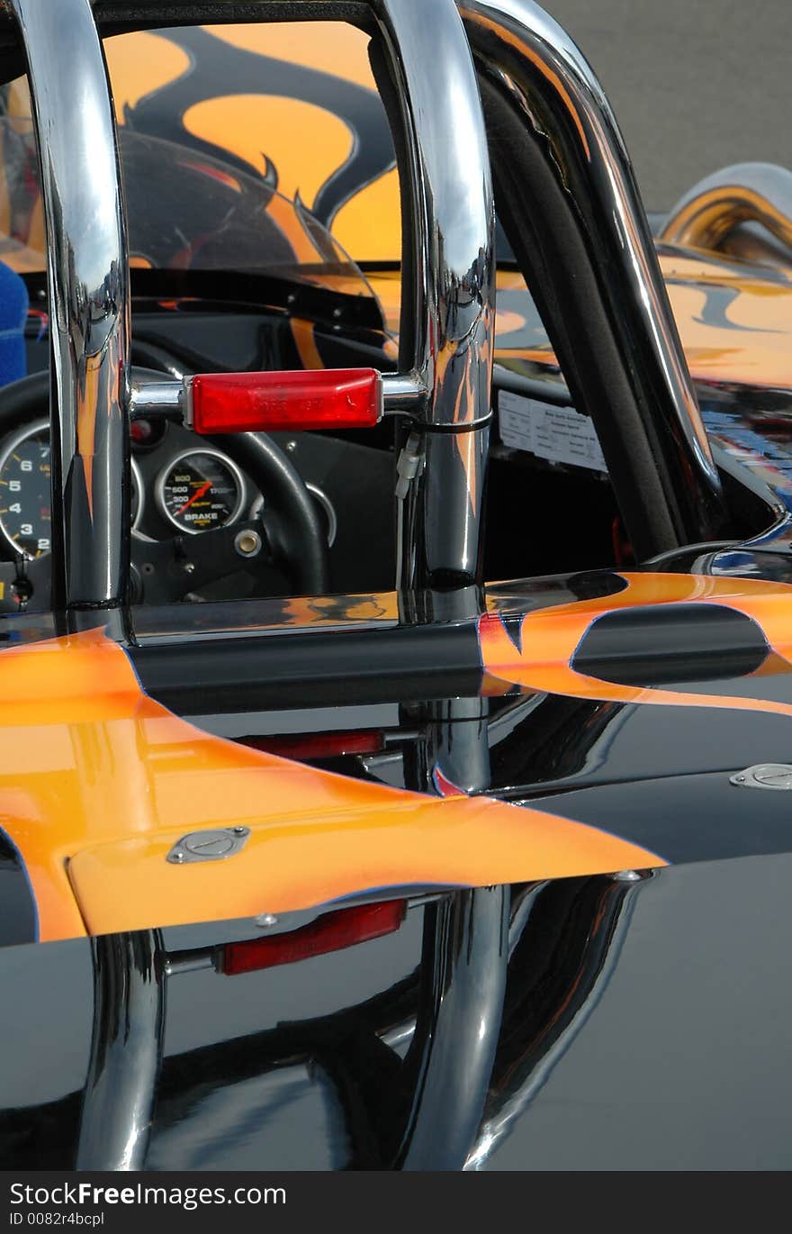 Close-up of custom car roll-cage and paintwork.
