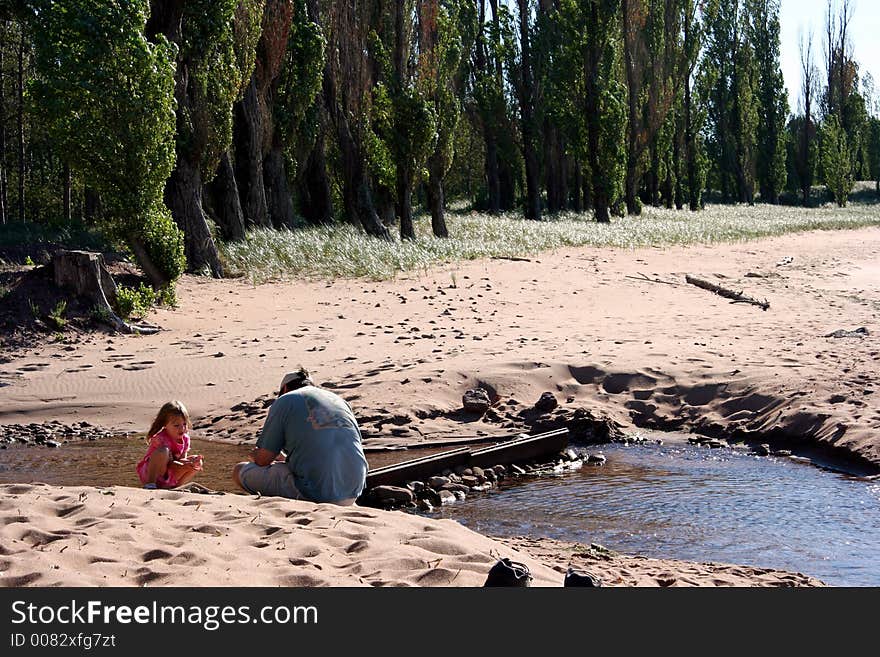 A father teaches his daughter about the wonders of nature. A father teaches his daughter about the wonders of nature.