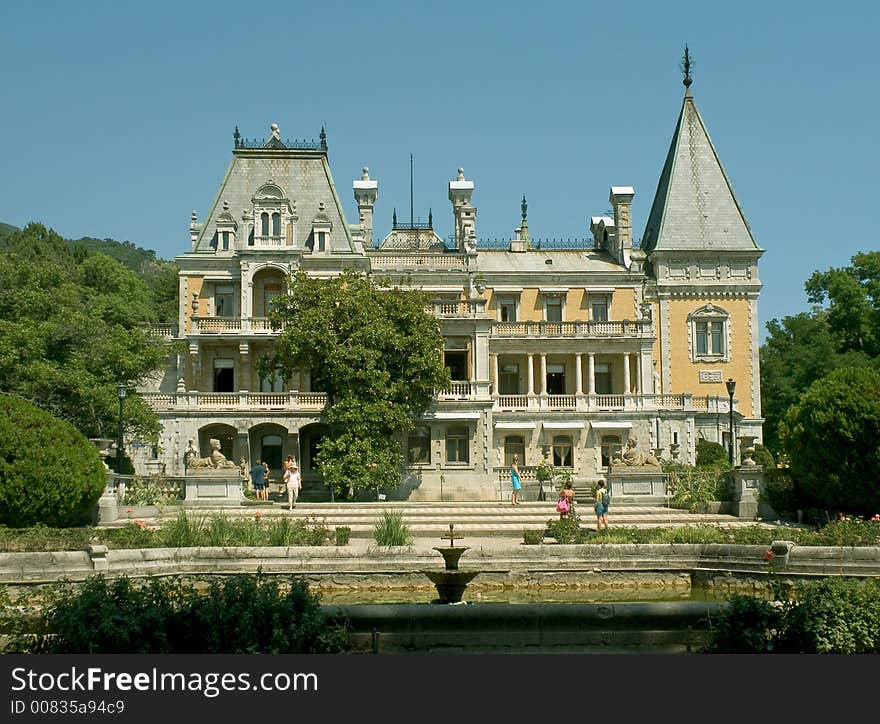 Old castle, trees and fountain