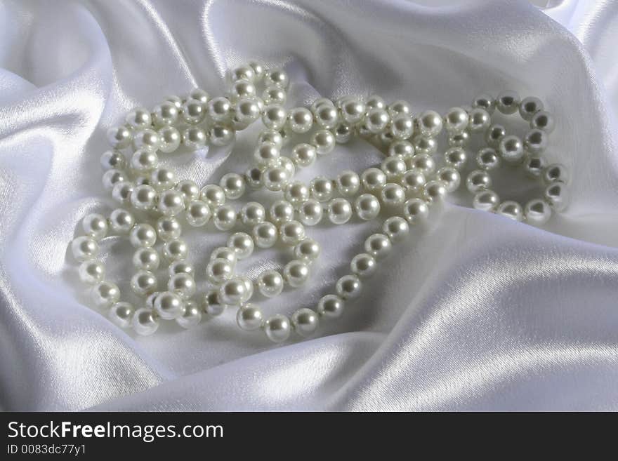 Pearls a necklace on a silk fabric