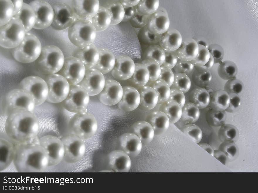 Pearls a necklace on a silk fabric