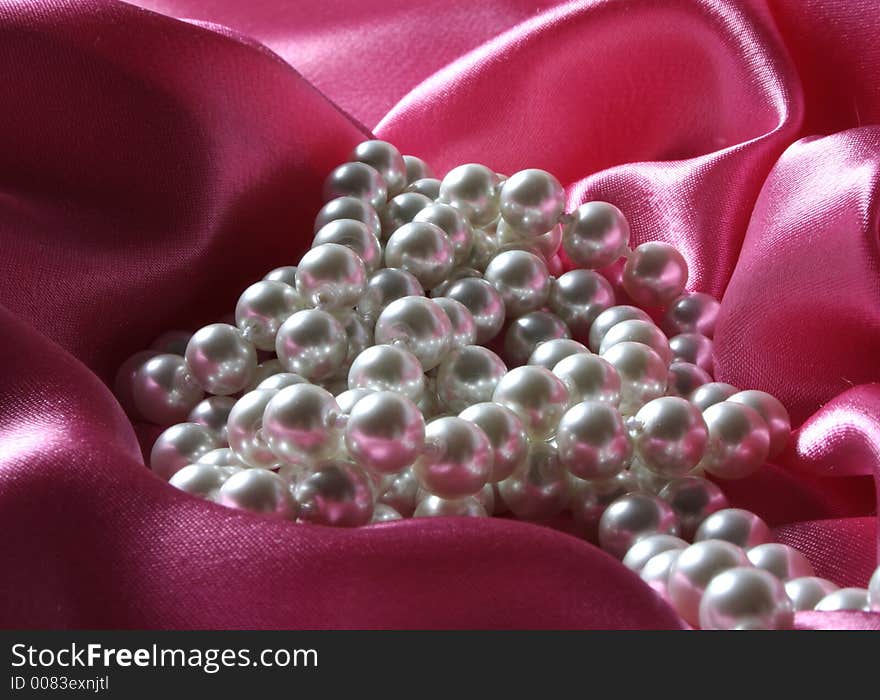 Pearls a necklace on a silk fabric