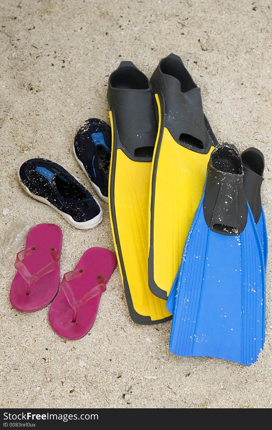 Shoes and flippers on sand. Shoes and flippers on sand