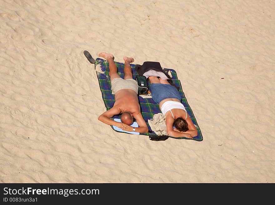 A couple sunbathing on a beach in Cornwall September 2006. A couple sunbathing on a beach in Cornwall September 2006