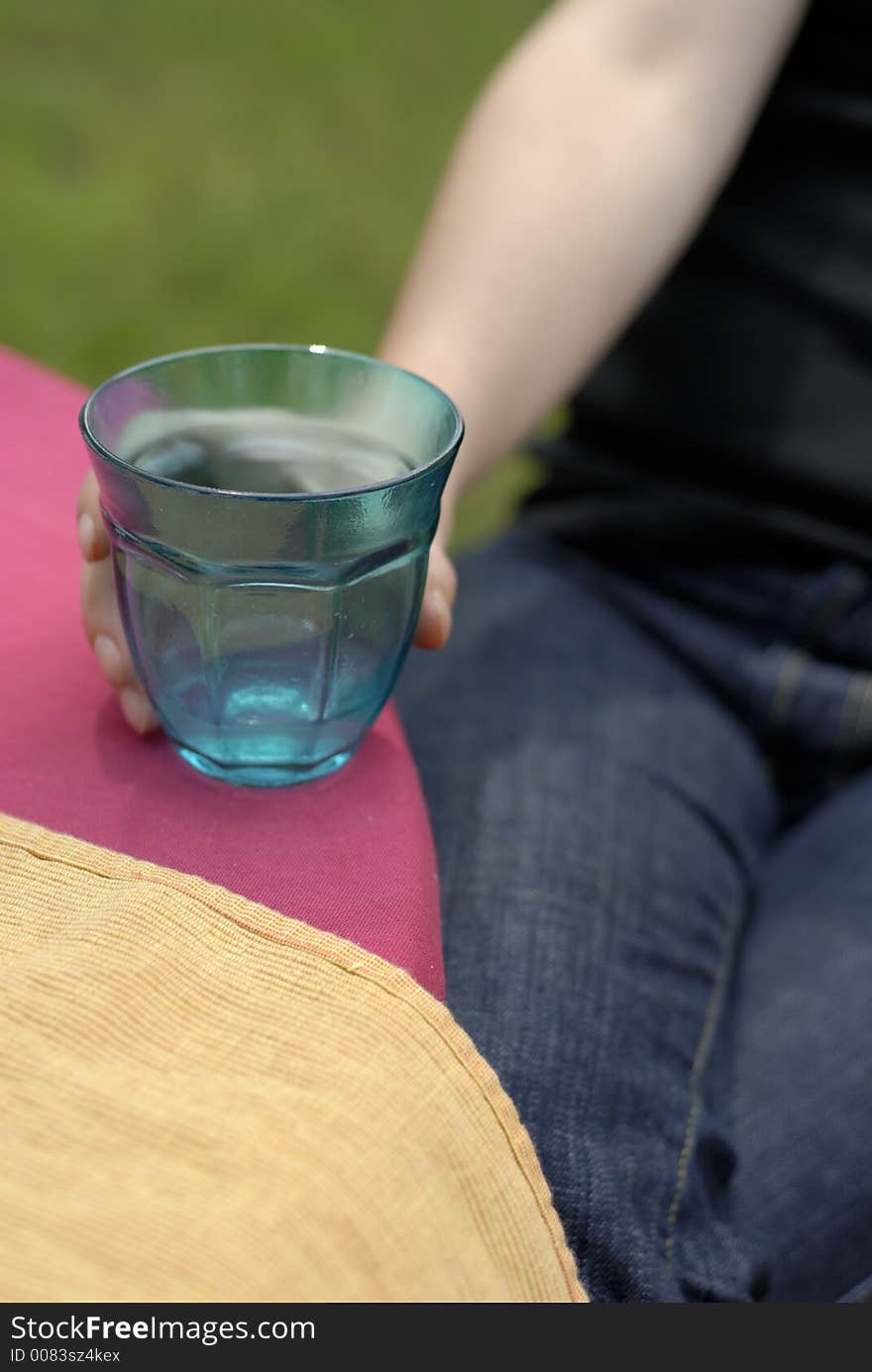 Female Hand Holding A Turquoise Glass