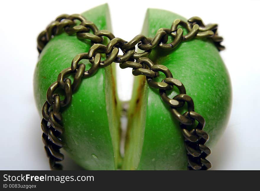 Cutted apple, locked between chains. Cutted apple, locked between chains.