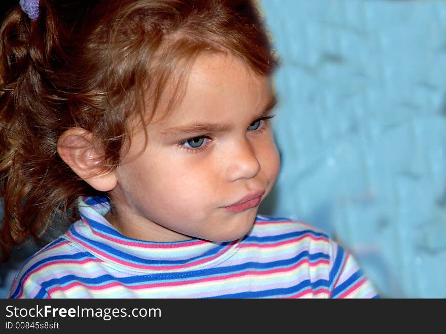 A young girl with big blue eyes and pigtails. A young girl with big blue eyes and pigtails.