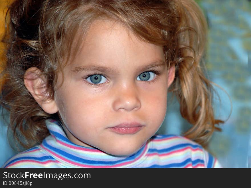 A young girl with big blue eyes and pigtails. A young girl with big blue eyes and pigtails.