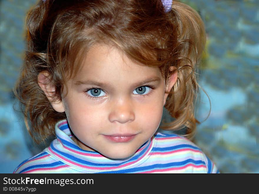 A young girl with big blue eyes and pigtails. A young girl with big blue eyes and pigtails.