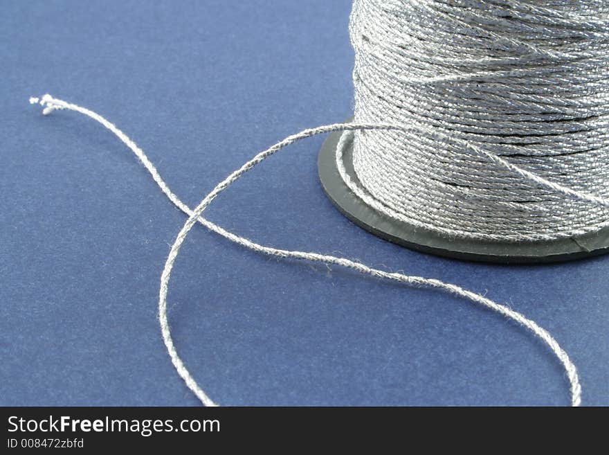 Silver Thread on a blue background