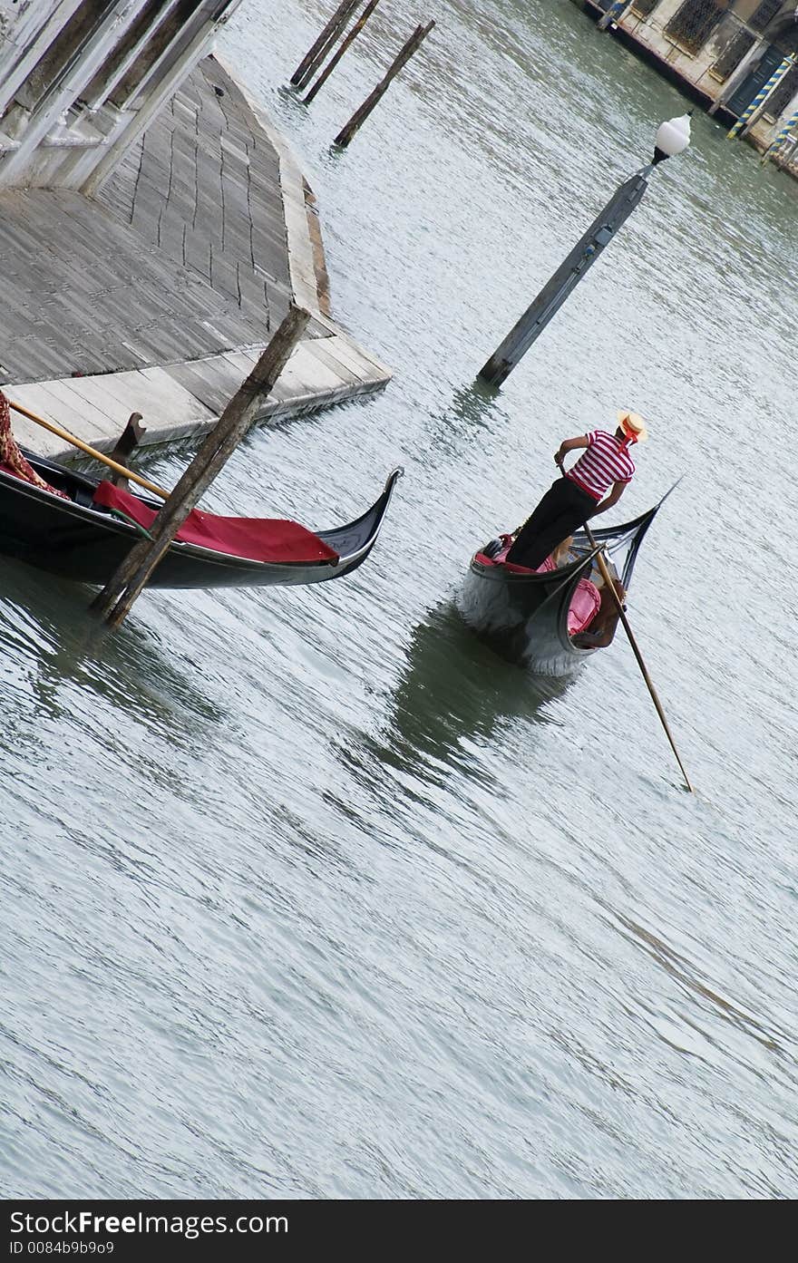 A view of a gondola driver in Venice, Italy. A view of a gondola driver in Venice, Italy