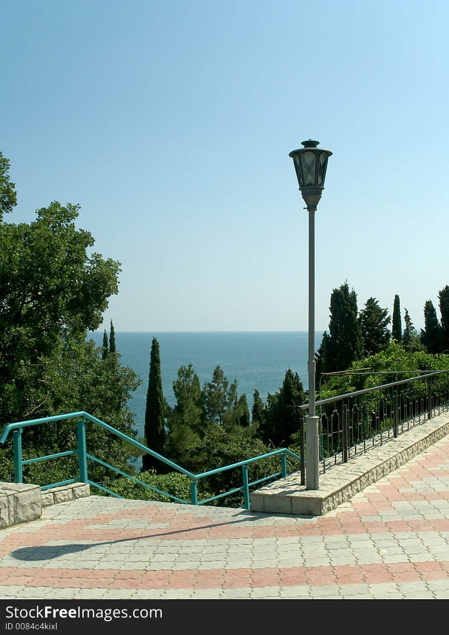 Pathway to sea, staircase and lamp