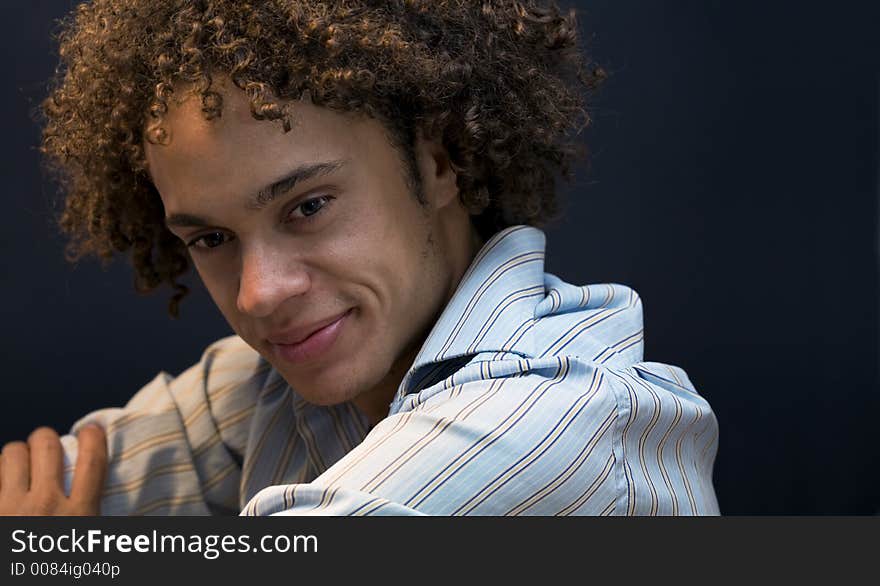 Nice guy smiling against a dark grey background. Nice guy smiling against a dark grey background