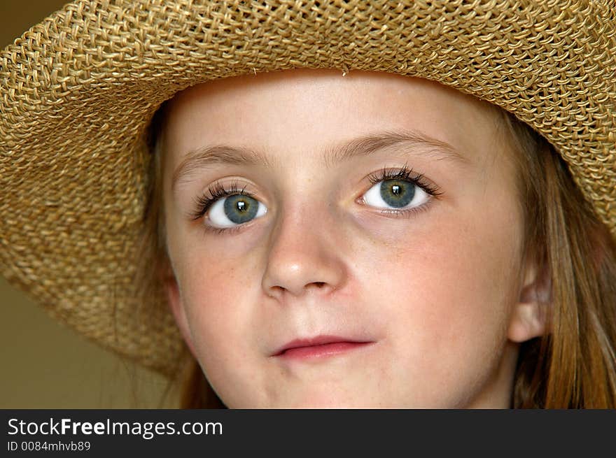 Little girl wearing straw hat with big eyes. Little girl wearing straw hat with big eyes