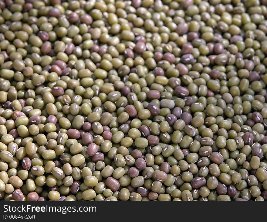 Closeup of mung beans also known as sprouting beans. Used a wide aperture to attain a shallow depth of field causing the bottom beans appear sharp and the top purposely fuzzier to get a false sense of 3 D