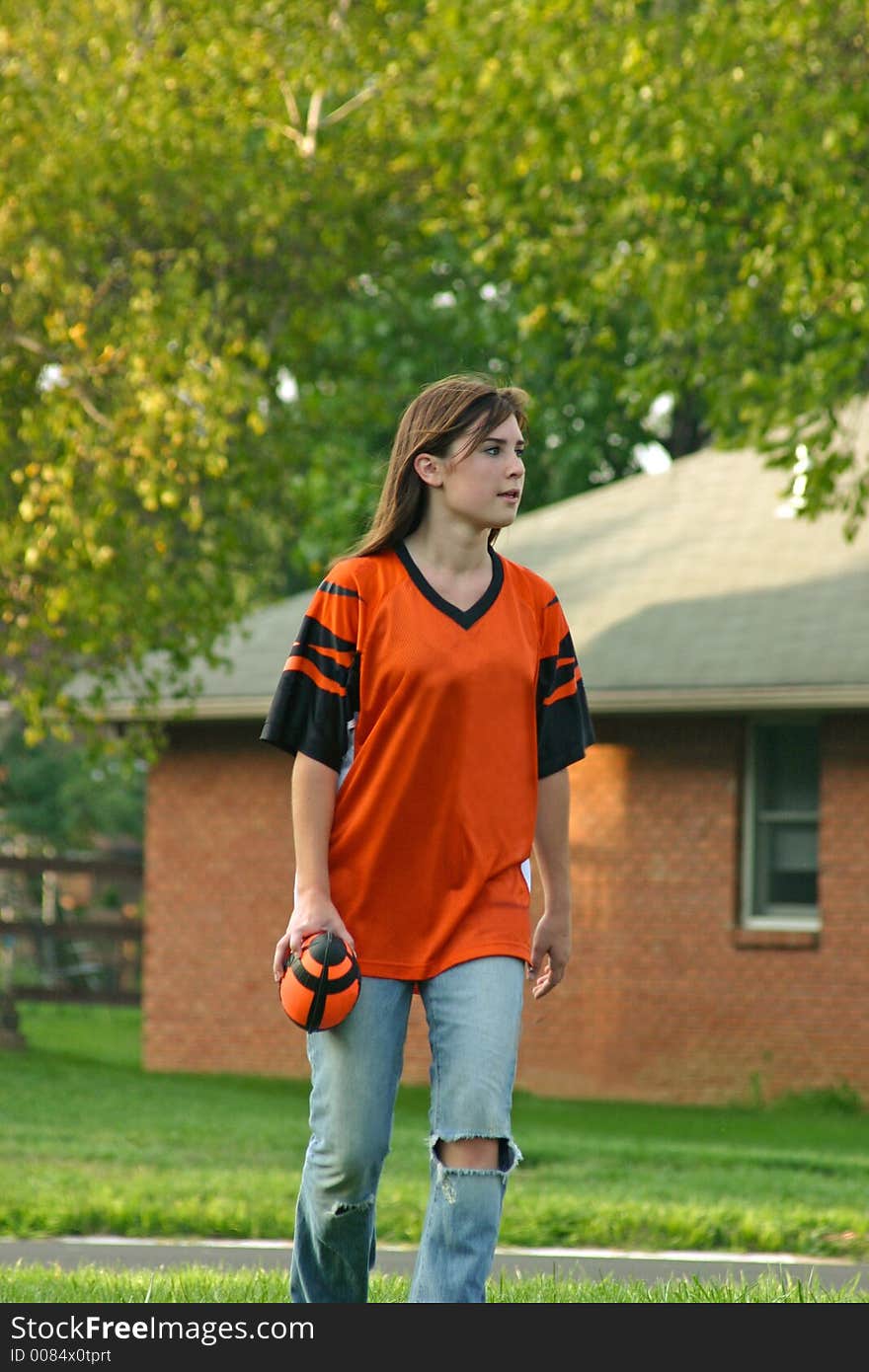 Girl holding football playing backyard football. Girl holding football playing backyard football