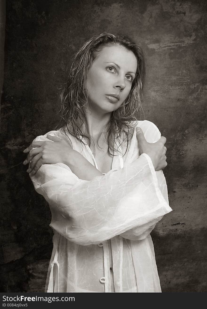 The portrait of the thoughtful girl, hands are crossed on a breast. b/w+sepia. The portrait of the thoughtful girl, hands are crossed on a breast. b/w+sepia