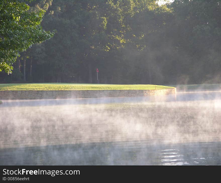 Golf hole in the morning fog. Golf hole in the morning fog