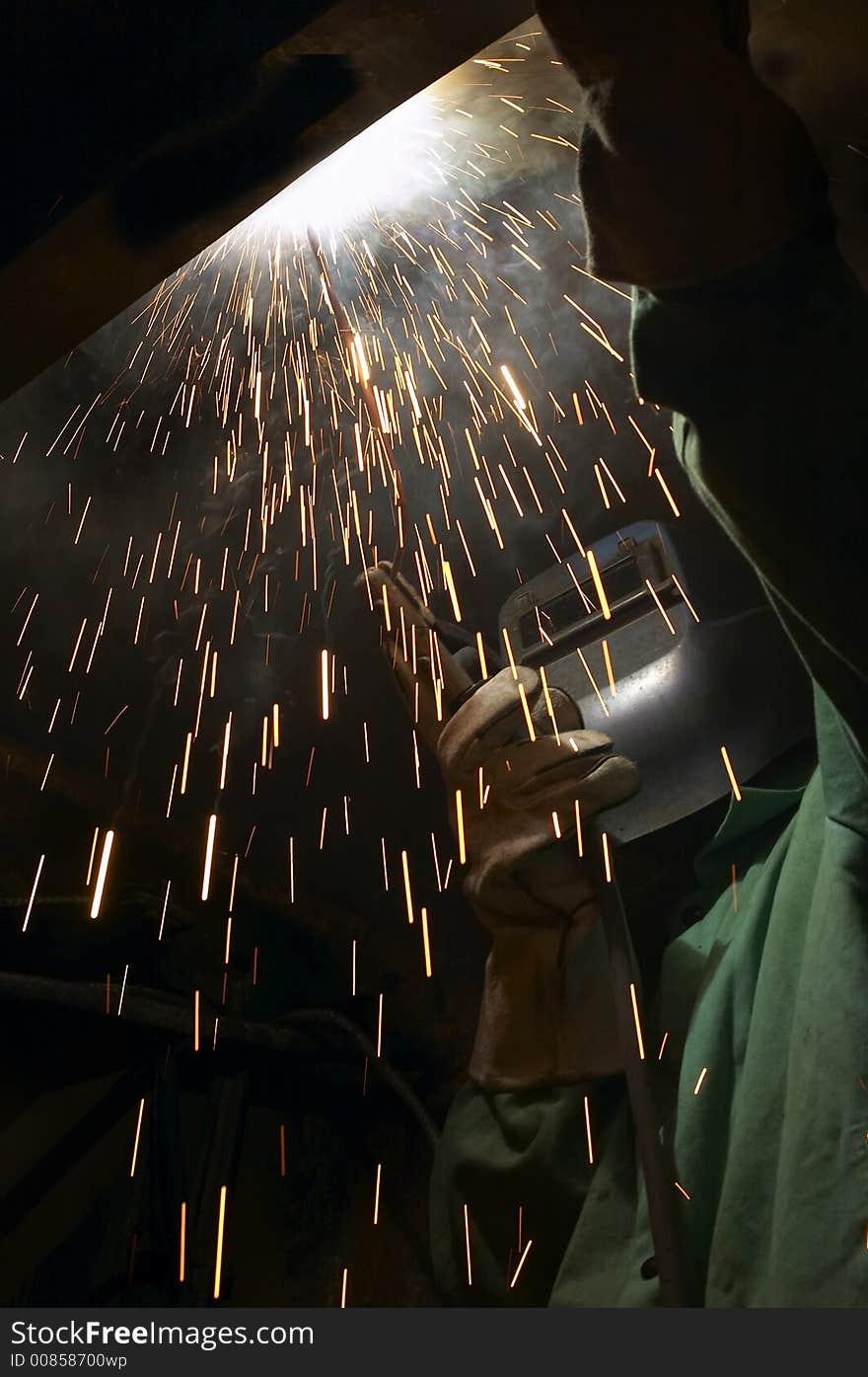 Welder working overhead at night. Welder working overhead at night